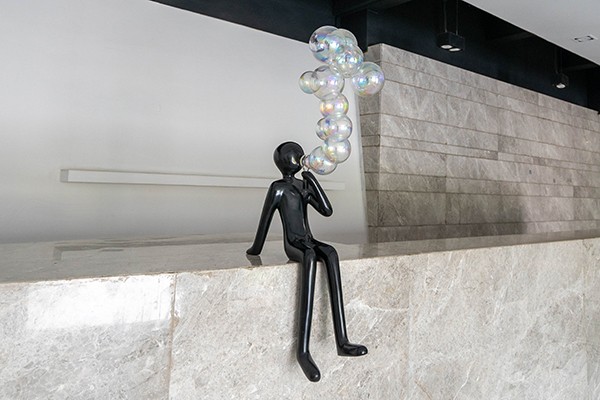 Elevate your interior or commercial space with this Fiberglass Sitting Figure Sculpture with Bubble Design  Elevate your interior or commercial space with this Fiberglass Sitting Figure Sculpture with Bubble Design